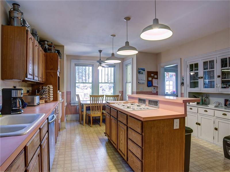 Kitchen with butler's pantry, wet bar and breakfast nook with wonderful lake view. Wood under the laminate floors.